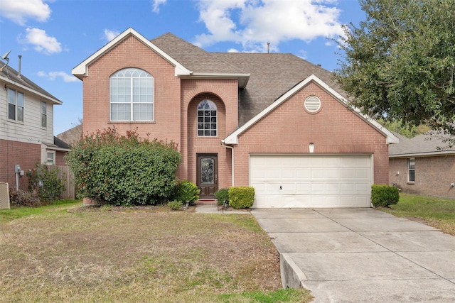 view of property featuring a front yard and a garage