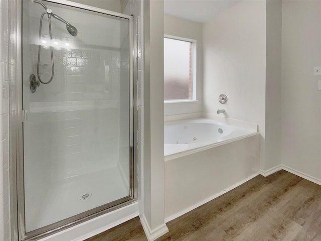 bathroom featuring hardwood / wood-style floors and independent shower and bath