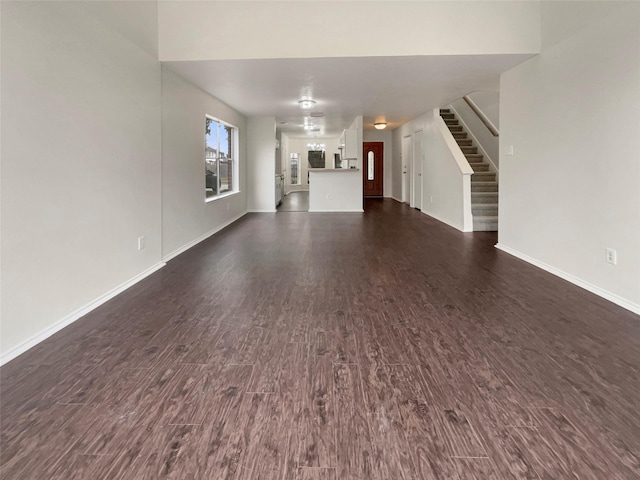 unfurnished living room with dark hardwood / wood-style flooring