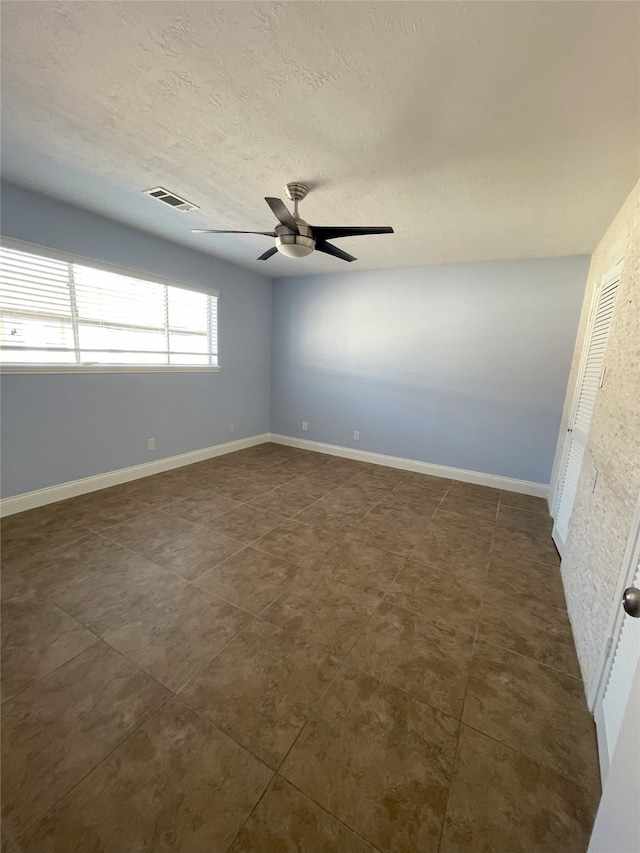 unfurnished room with ceiling fan