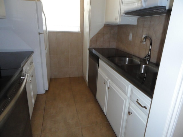 kitchen featuring white cabinets, range, sink, backsplash, and light tile patterned flooring