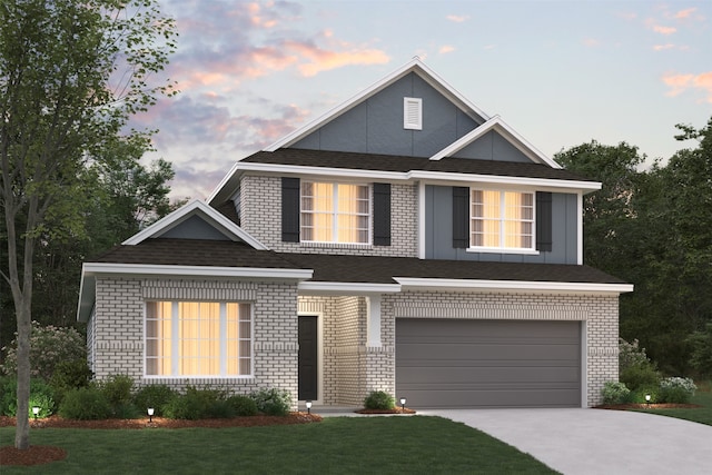 view of front facade with a garage, driveway, brick siding, and a lawn