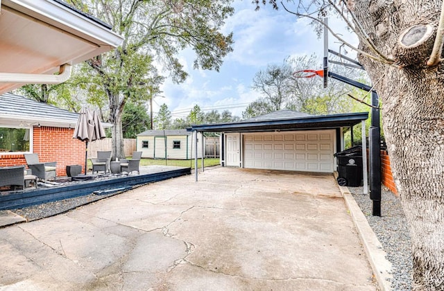 view of patio / terrace featuring a storage unit and a garage