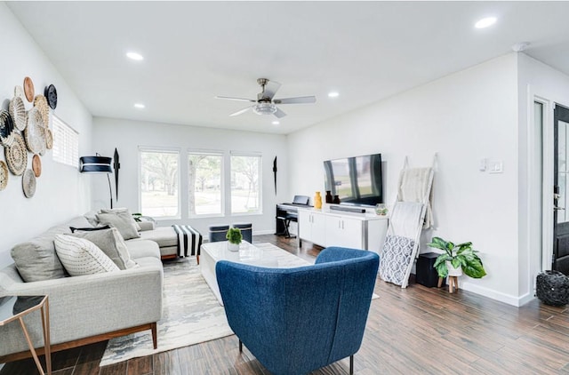 living room with ceiling fan and dark hardwood / wood-style flooring