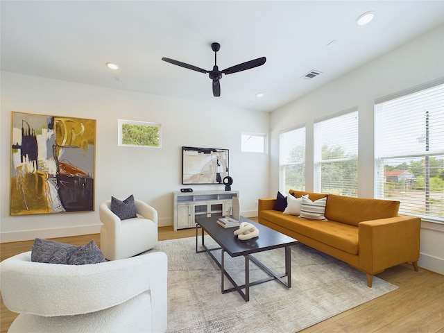 living room featuring light wood-type flooring and ceiling fan