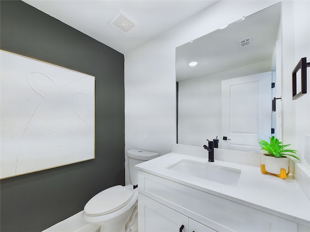 bathroom with toilet and vanity