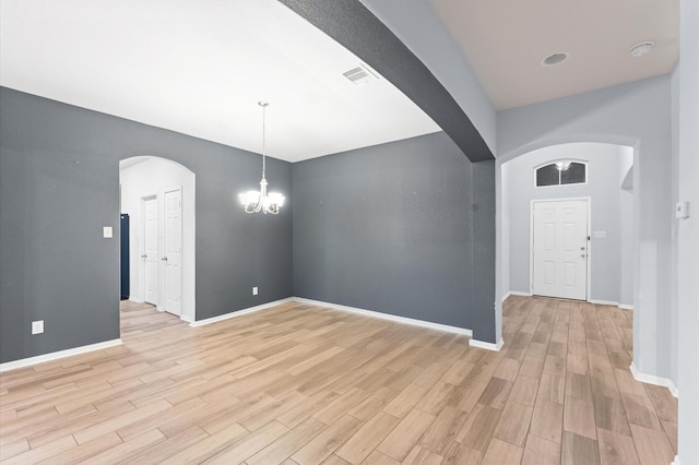 interior space featuring a chandelier and light wood-type flooring