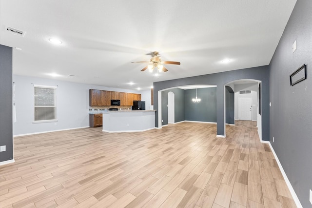 unfurnished living room with ceiling fan and light hardwood / wood-style floors