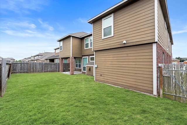 rear view of property featuring a lawn