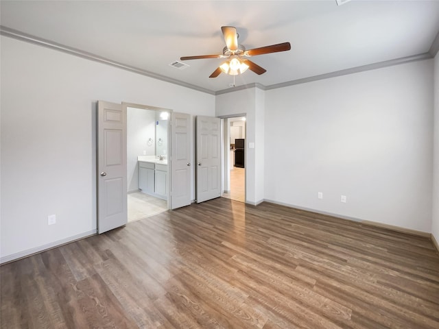 unfurnished bedroom with hardwood / wood-style flooring, ensuite bath, ceiling fan, and ornamental molding