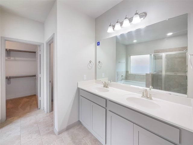 bathroom featuring tile patterned floors, vanity, and independent shower and bath