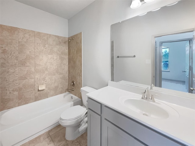 full bathroom with tiled shower / bath combo, vanity, toilet, and tile patterned flooring