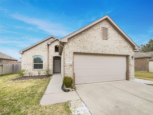 french provincial home with a garage and a front lawn