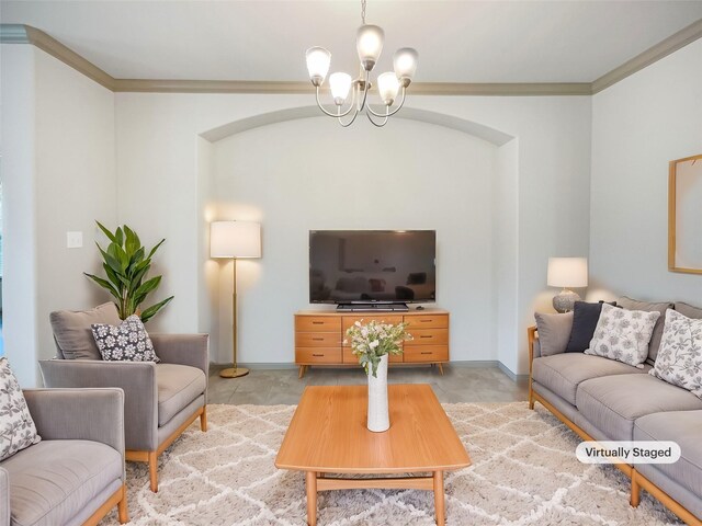 living room featuring crown molding and a notable chandelier