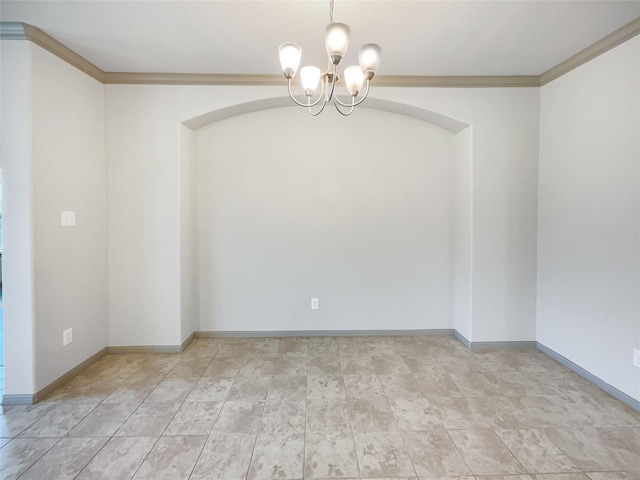 spare room featuring a notable chandelier and crown molding