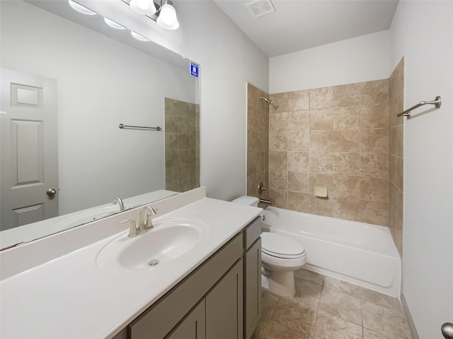 full bathroom featuring toilet, vanity, and tiled shower / bath