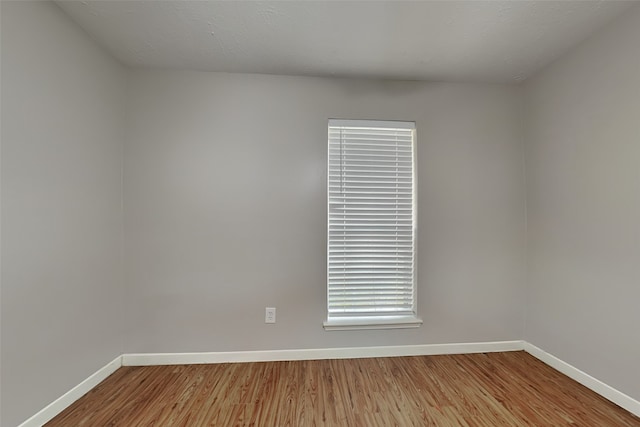 unfurnished room with light wood-type flooring