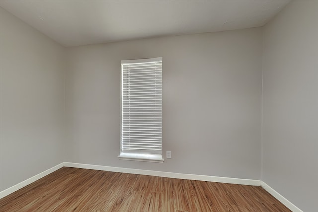 empty room with hardwood / wood-style flooring