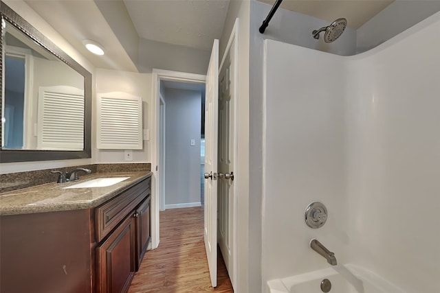 bathroom featuring shower / bath combination, wood-type flooring, and vanity