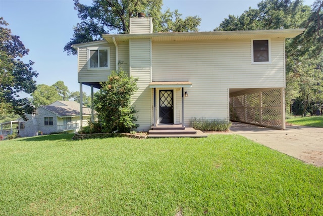 view of front of house with a front lawn and a carport