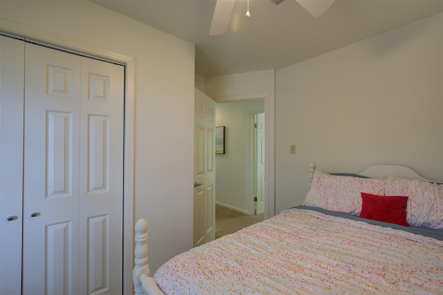 carpeted bedroom featuring ceiling fan and a closet