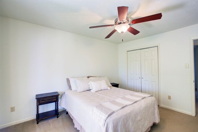 carpeted bedroom featuring ceiling fan and a closet