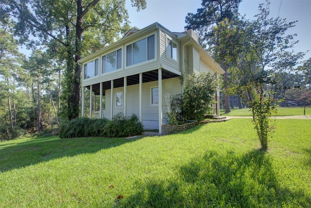 view of home's exterior with a lawn