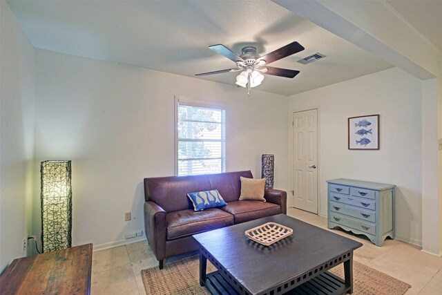 tiled living room with ceiling fan