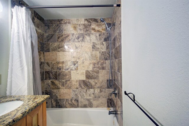 bathroom featuring shower / tub combo and vanity