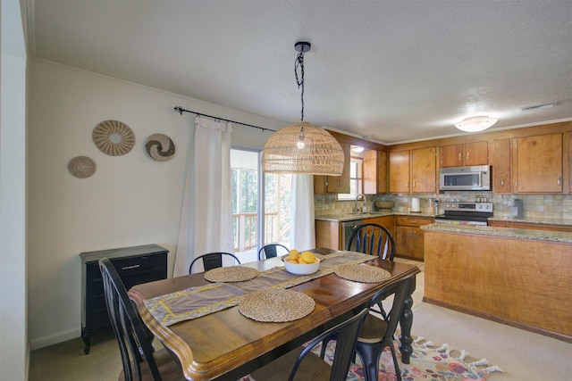 dining room featuring sink and a textured ceiling