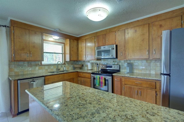 kitchen with decorative backsplash, sink, light tile patterned flooring, light stone countertops, and stainless steel appliances