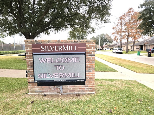 community sign featuring a yard