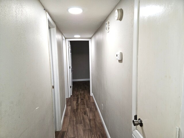 hallway featuring dark hardwood / wood-style flooring