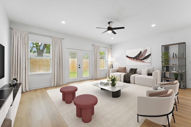 living room featuring french doors, ceiling fan, plenty of natural light, and light hardwood / wood-style flooring