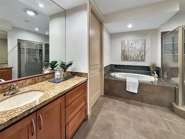 bathroom featuring vanity, tile patterned floors, and plus walk in shower