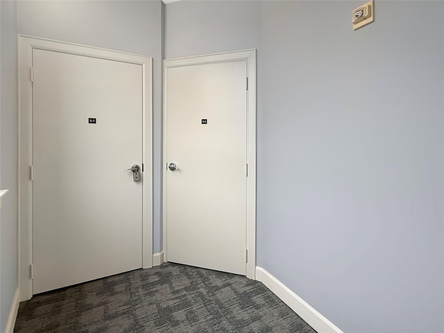 doorway featuring dark colored carpet