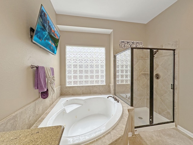 bathroom featuring separate shower and tub