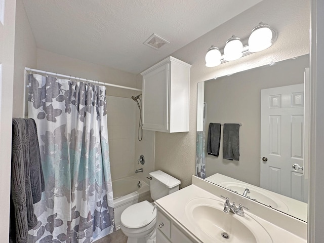 full bathroom with shower / tub combo with curtain, vanity, toilet, and a textured ceiling