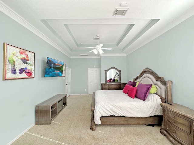 bedroom featuring ornamental molding, light colored carpet, a raised ceiling, and ceiling fan