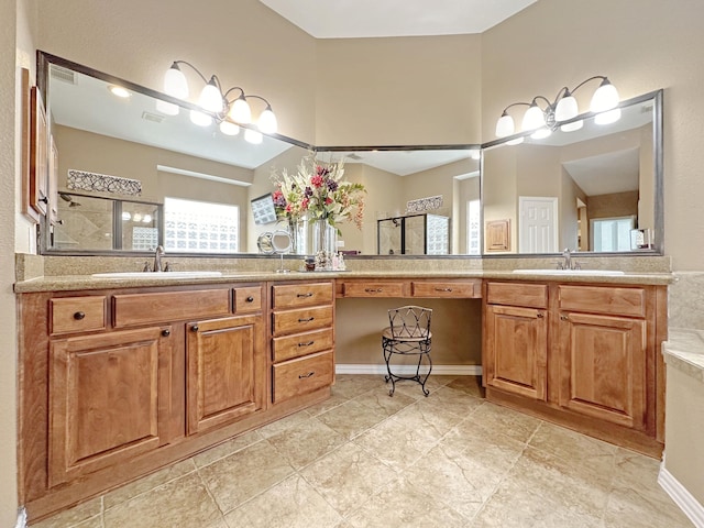 bathroom with vanity, a wealth of natural light, and a shower with shower door