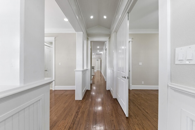 hallway featuring ornamental molding, dark hardwood / wood-style floors, and vaulted ceiling