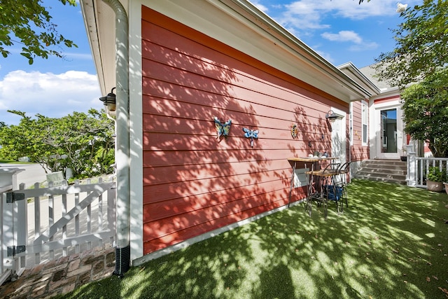 view of property exterior with a lawn