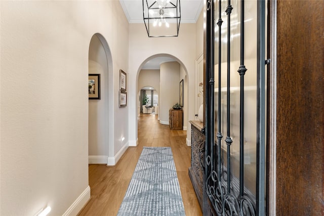 foyer entrance featuring ornamental molding and light hardwood / wood-style floors