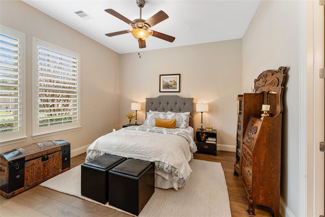 bedroom with ceiling fan and wood-type flooring