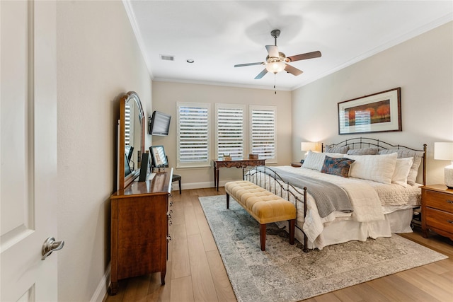 bedroom with ceiling fan, light hardwood / wood-style flooring, and crown molding