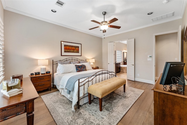 bedroom with ceiling fan, connected bathroom, ornamental molding, and light wood-type flooring