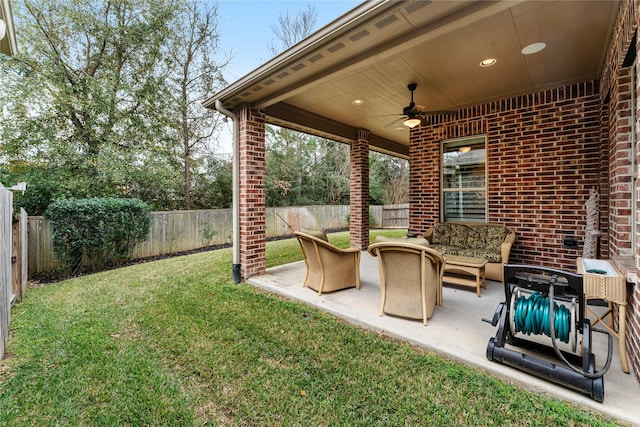 view of yard featuring an outdoor hangout area, ceiling fan, and a patio area