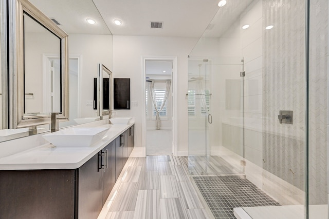 bathroom featuring walk in shower and vanity