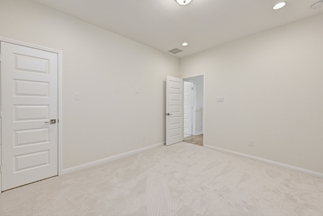 unfurnished room featuring light colored carpet