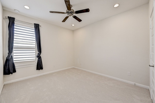 carpeted empty room featuring ceiling fan